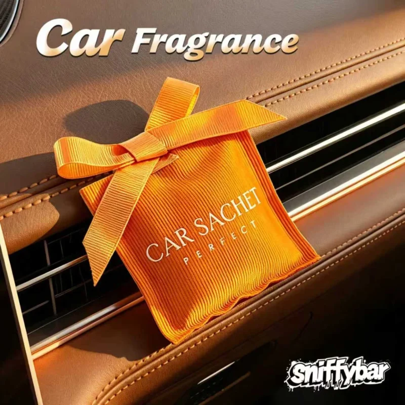 Sniffybar Nose Inhaler: Refresh & Focus On-the-Go 3 CARSACHET Giselle orange car sachet with ribbon bow hanging on a car air vent