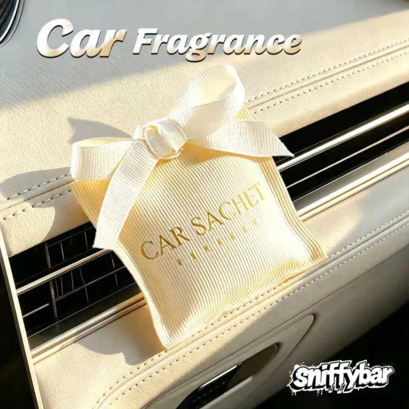 CARSACHET Swan Lake cream car sachet with ribbon bow on a car air vent